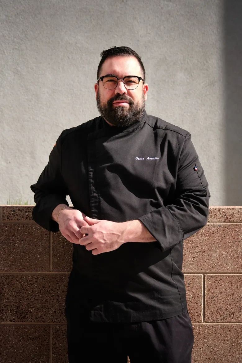 Chef Oscar Amador in a black chef coat